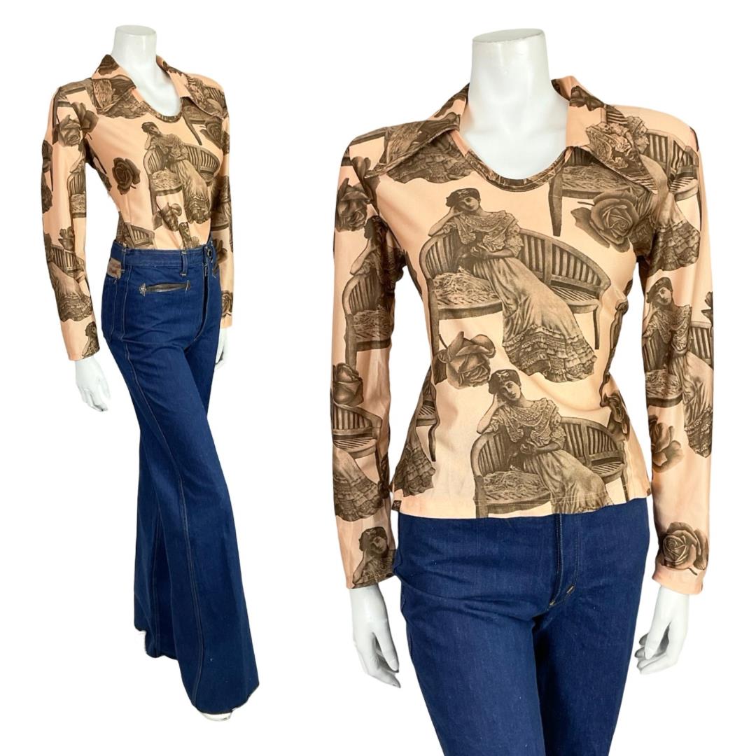 Mannequin wears a 60s 70s beige and brown Edwardian lady printed dagger collar shirt with blue flared jeans. 
