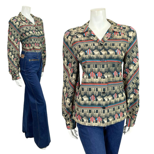 Mannequin wears a 60s 70s beige black and red geometric open collar shirt with blue flared jeans. 
