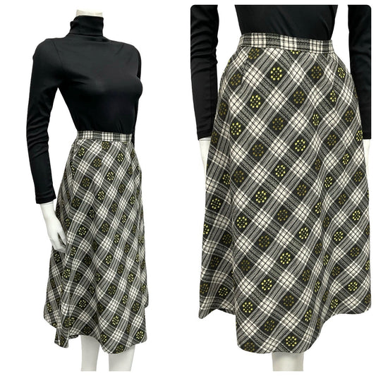 Mannequin wears a 60s 70s black white and yellow plaid floral print midi skirt with a black turtleneck 
