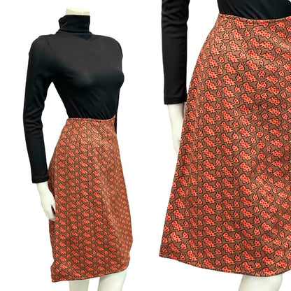 Mannequin wears a 60s 70s orange and black psychedelic wavy print midi skirt with a black turtleneck
