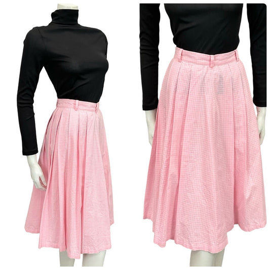 Mannequin wears a 60s 70s light pink and white geometric grid print pleated midi skirt with a black turtleneck