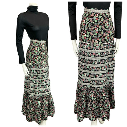 Mannequin wears a 70s black and green folk floral printed tiered skirt with a black turtleneck
