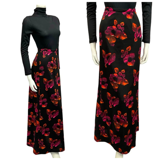 Mannequin wears a 60s 70s black and orange floral print maxi skirt with a black turtleneck