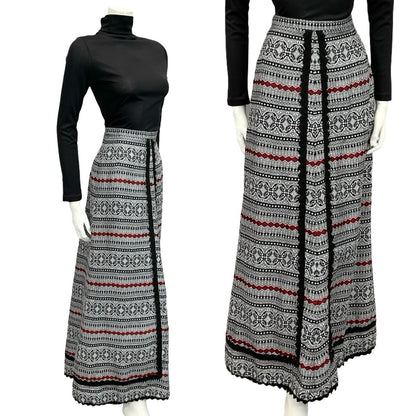 Mannequin wears a 60s 70s white black and red folk ric rac maxi skirt with a black turtleneck