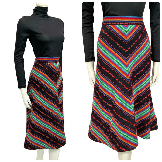 Mannequin wears a black and rainbow chevron woven midi skirt with a black turtleneck