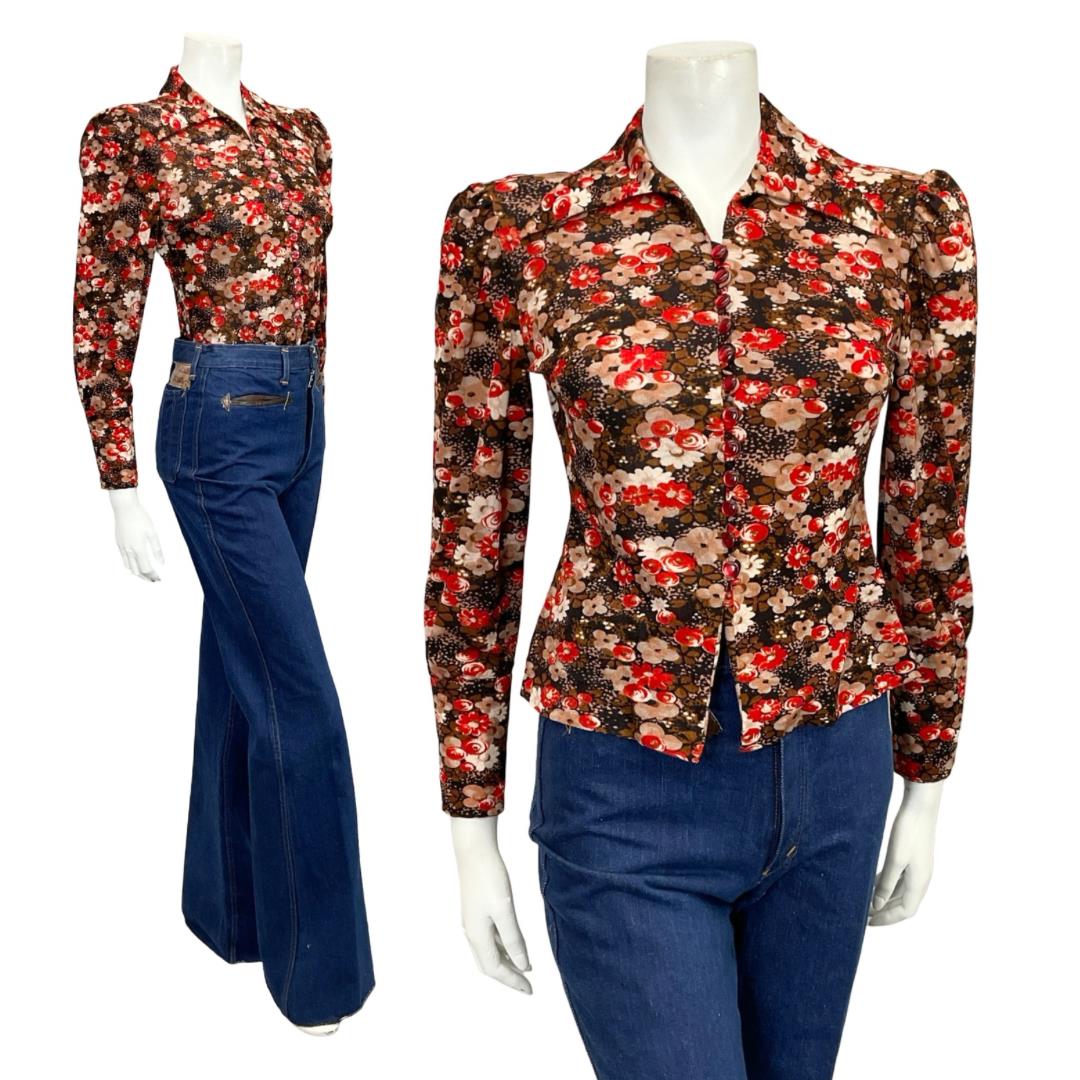 Mannequin wears a blue and red floral printed 60s 70s dagger collar blouse with blue flared jeans 