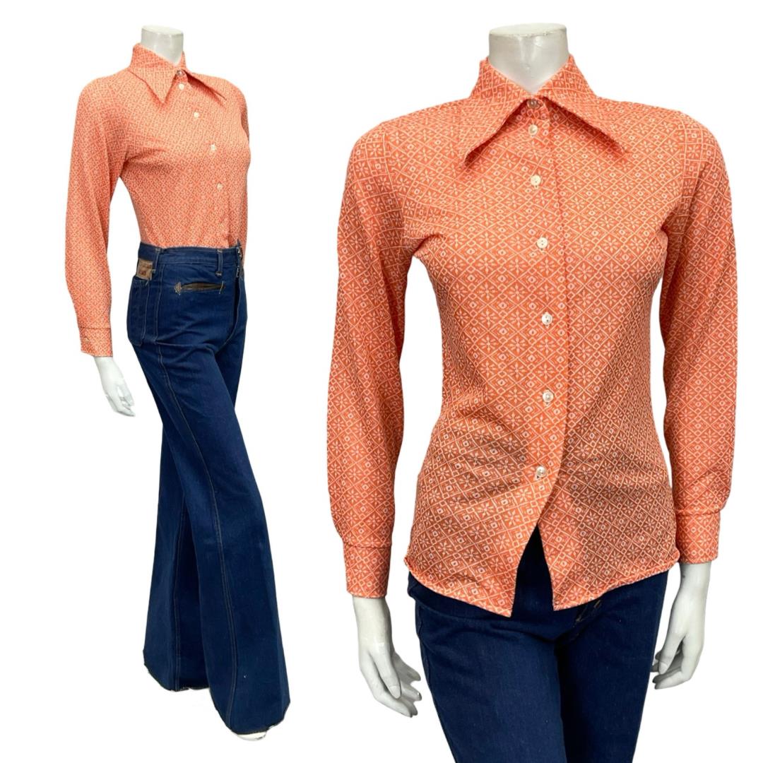 Mannequin wears a 60s 70s orange and white geometric tile print dagger collar shirt with blue flared jeans 