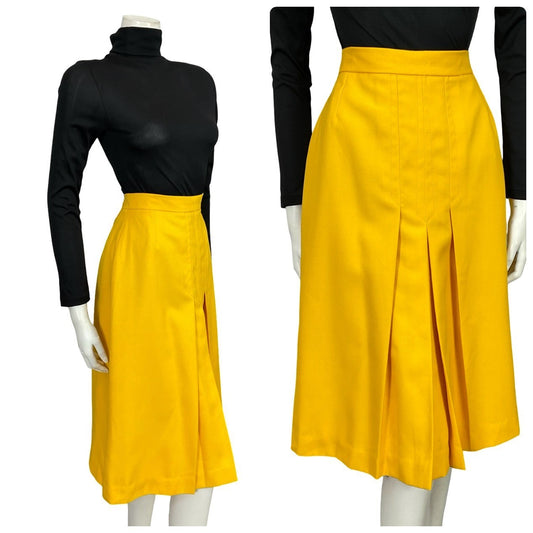 Mannequin wears a 60s 70s bright yellow pleated mini skirt with a black turtleneck 