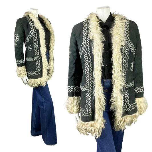 Shrinking Violets Vintage black suede cream shearling with floral embroidery on a mannequin wearing blue flared jeans 