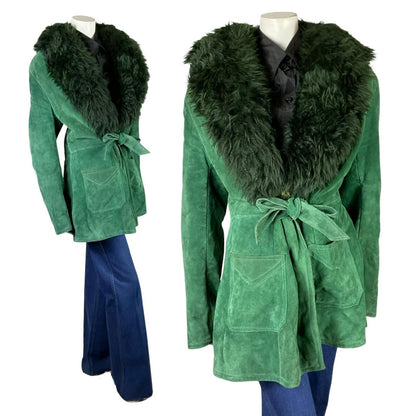 Shrinking Violets Vintage 60s 70s green suede boho tie waist shearling coat on a white mannequin wearing blue flared jeans