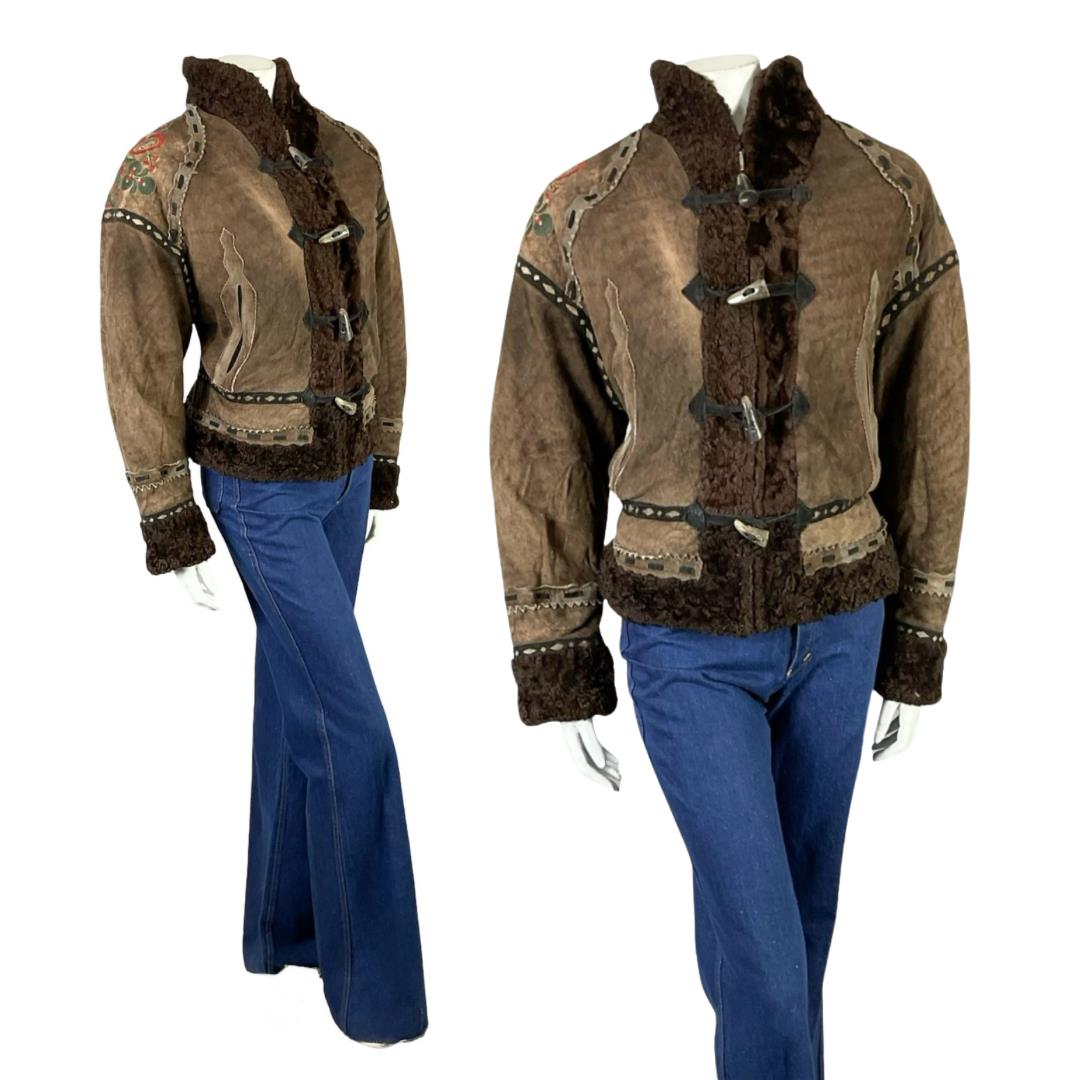 Vintage 60s 70s brown suede boho die cut ribbon shearling zip up coat on a mannequin with blue flared jeans
