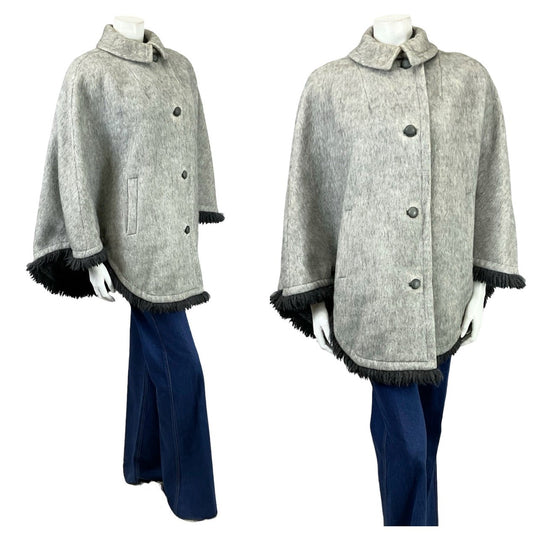 Shrinking Violets Vintage 0s 70s grey wool cape with black fringe on a mannequin with blue flared jeans 