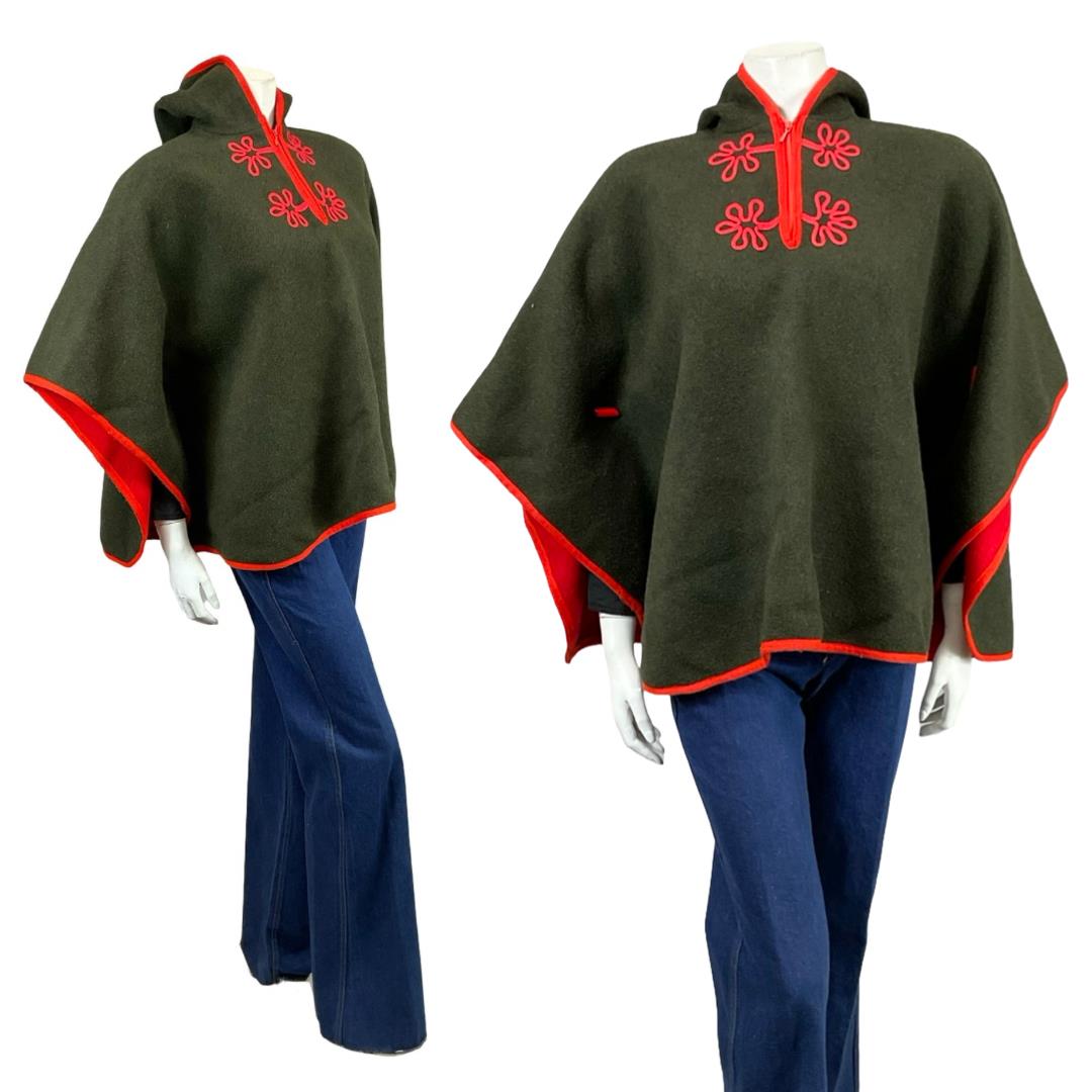 Shrinking Violets vintage black and red 60s 70s folk hippy felt wool hooded cape with flower embroidery and trim on a mannequin wearing blue flared jeans 