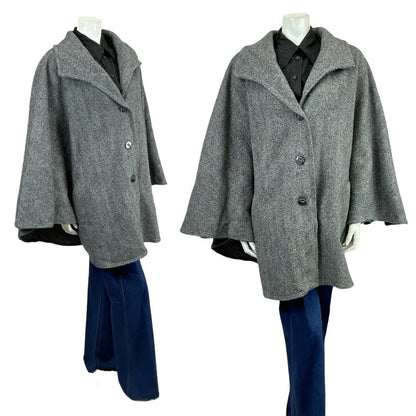 Vintage 60s 70s charcoal grey chevron wool cape on a white mannequin with blue flared jeans 