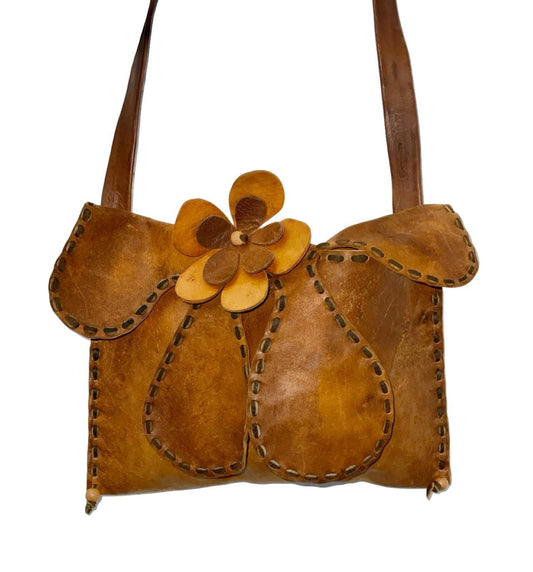 Vintage 60s 70s tan brown leather shoulder bag with wavy psychedelic stitched flap and applique leather flower. 