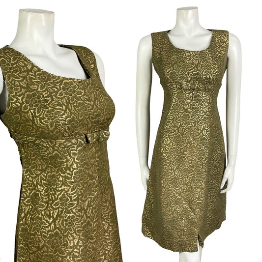 Mannequin wears a gold and khaki green floral damask sleeveless empire party dress with a bow detail at the bust. 
