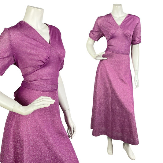 Mannequin wears a vintage 60s 70s fuchsia purple lurex maxi dress with short ruched sleeves and a V neckline. 