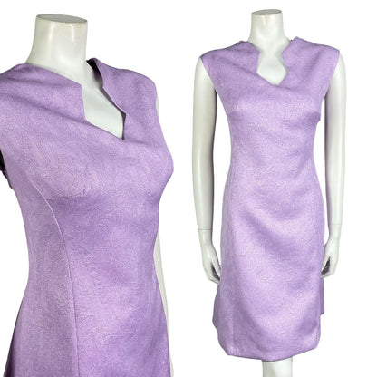 Mannequin wears a vintage 60s 70s purple lilac geometric space age mod shift dress. 