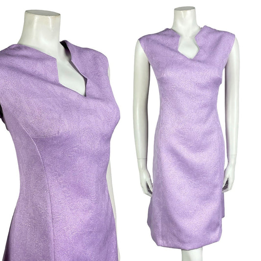 Mannequin wears a vintage 60s 70s purple lilac geometric space age mod shift dress. 