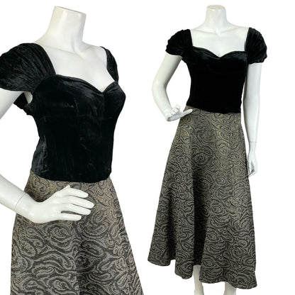 Mannequin wears a vintage 60s evening maxi dress with a black velvet cap sleeve sweetheart bodice, and bronze swirl damask skirt. 