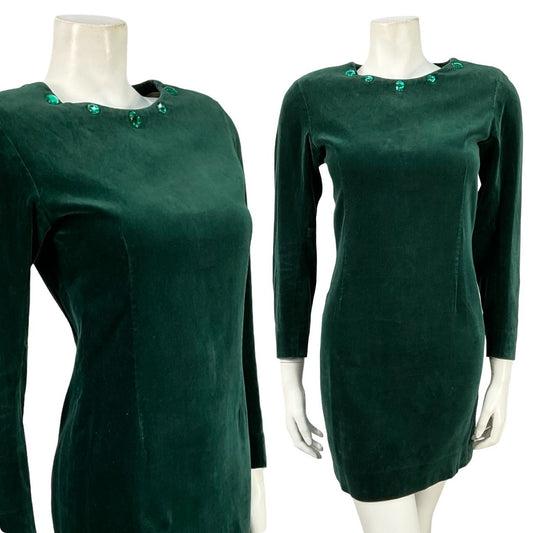 Mannequin wears a vintage 60s 70s long sleeve green velvet shift dress with a beaded neckline. 