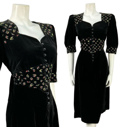 Mannequin wears a black velvet puff sleeve, sweetheart midi dress with a floral print waistband. 