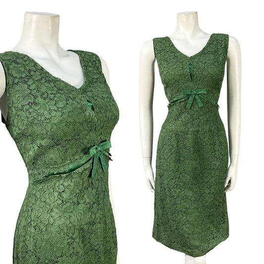 Mannequin wears a vintage handmade 60s green V-neck mini party dress in a green lace and satin. 