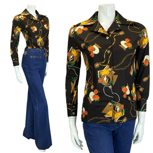 Mannequin wears blue flared jeans with a brown and yellow dagger collar 70s shirt, printed with an art deco design featuring roses, a necklace and a woman. 
