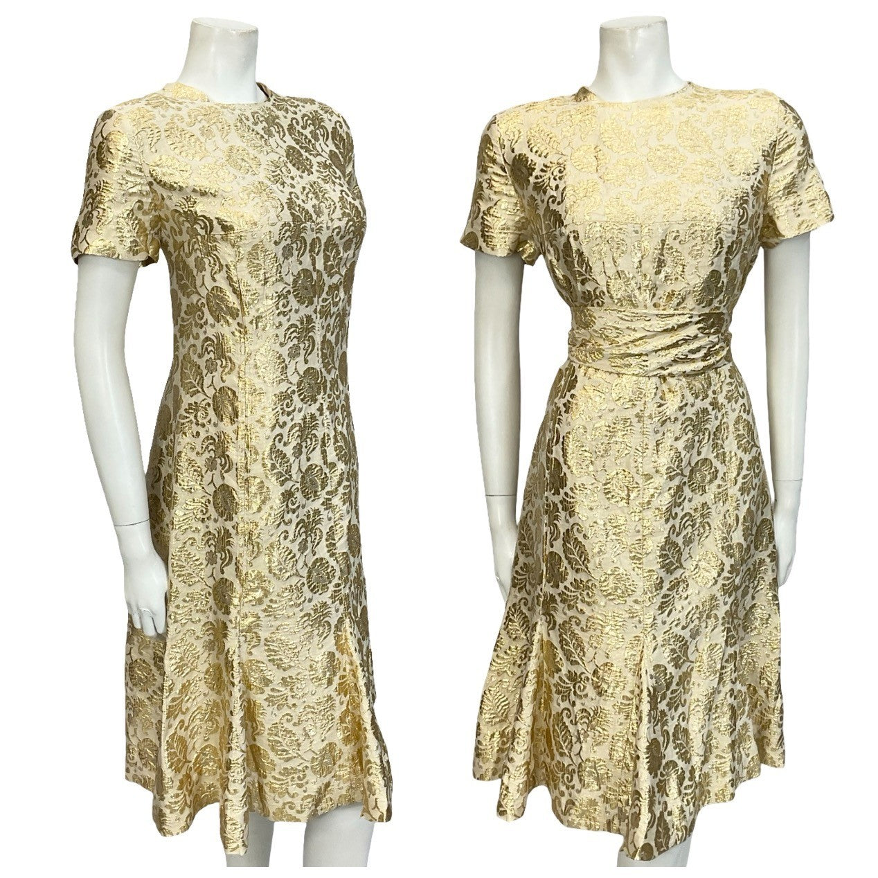 Mannequin wears a gold floral lurex damask short sleeved shift dress with a flared hem and tie waist.