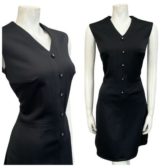 Mannequin wears a 60s sleeveless V neck mod black monochrome mini dress.