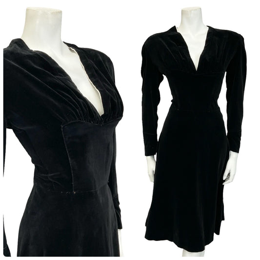 Mannequin wears a handmade 60s 70s long sleeve plunging neck black velvet midi dress.