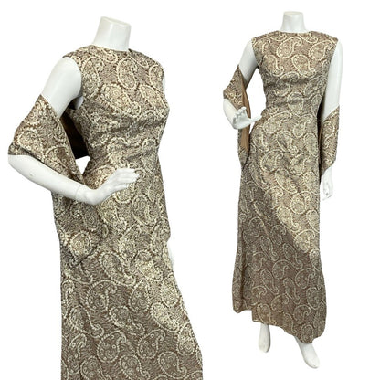 Mannequin wears a brown and gold paisley lurex glittery mod shift maxi dress with sash.