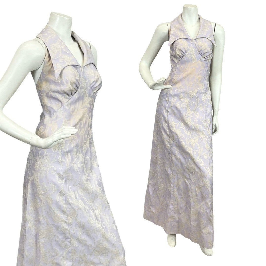 Mannequin wears a lilac purple and gold glittery lurex psychedelic halter neck maxi dress. 