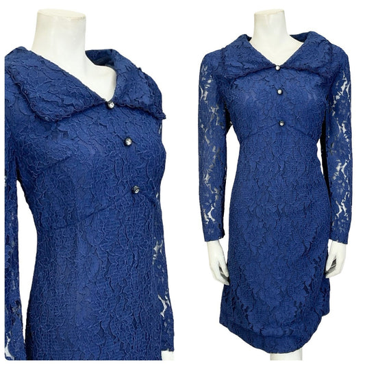 Mannequin wears a navy blue lace 60s 70s long sleeve diamante button empire mini shirt dress. 
