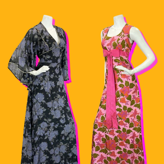 The mannequin on the left is wearing a black and blue floral cape sleeve maxi dress that has gold trim along the seams. The mannequin on the right is wearing a baby pink sleeveless empire line dress, decorated with a bright pink bow across the waist, and is patterned with pink flowers and butterflies