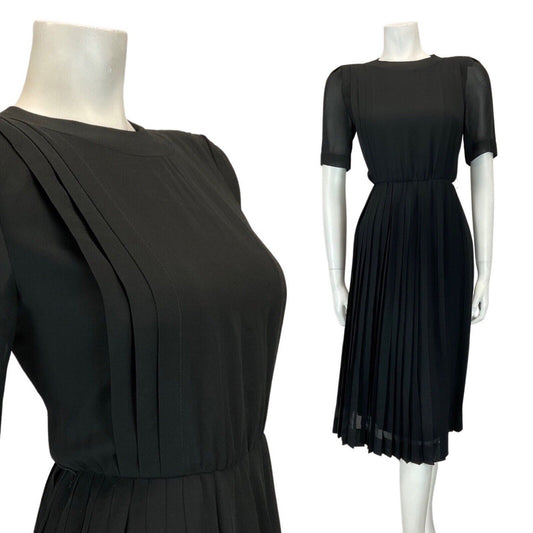 Mannequin wears a vintage 60s Pierre Cardin black pleated short sleeve dress