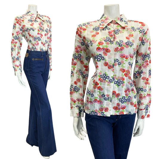 mannequin wears blue flared jeans and a white shirt patterned with red poppies and blue flowers