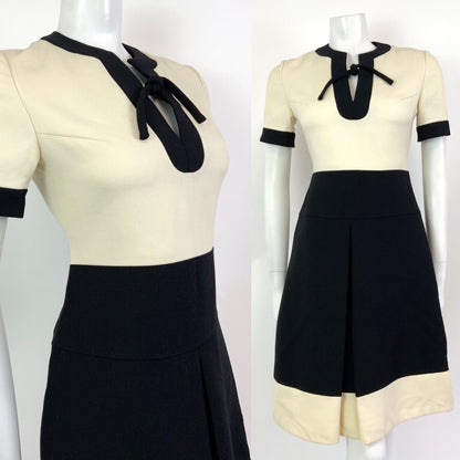 mannequin wears a cream and black Louis Feraud colour blocked mod dress. 